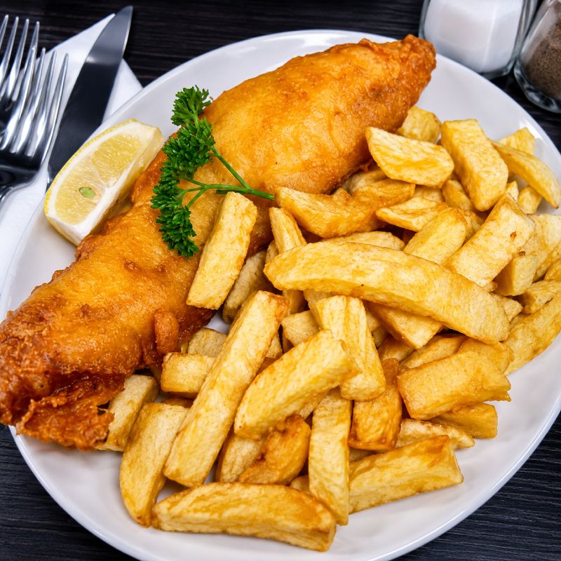 fish & chips with lemon & sauce in a newspaper served at Dani's Takeaway Midlothian